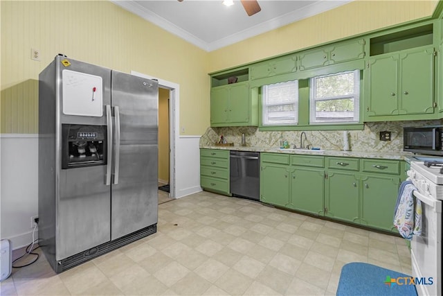 212 Whitfield St, Yoakum, TX 77995 - kitchen with stainless steel appliances, light countertops, a sink, green cabinets, and crown molding