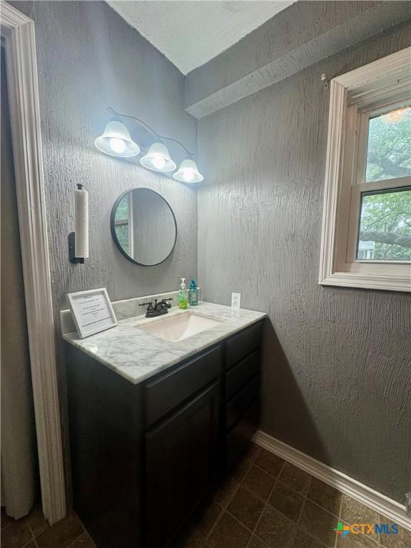 212 Whitfield St, Yoakum, TX 77995 - bathroom featuring vanity and baseboards
