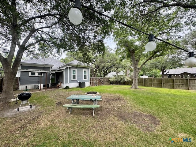 212 Whitfield St, Yoakum, TX 77995 - view of yard featuring an outdoor fire pit and central AC