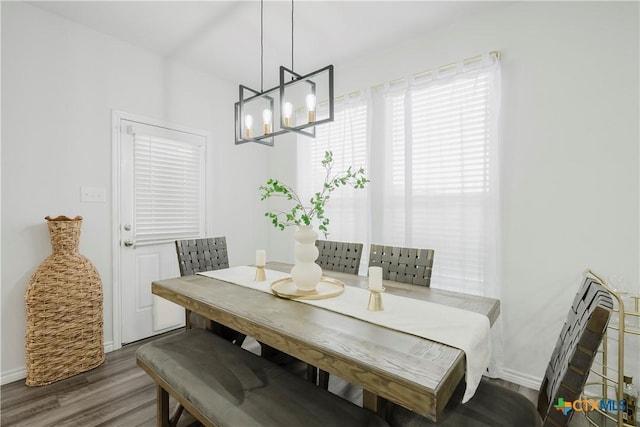 dining space featuring dark hardwood / wood-style floors and a notable chandelier