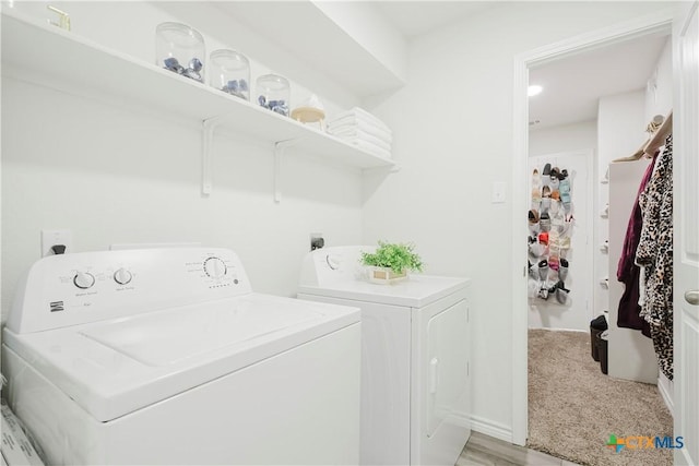 laundry room featuring light carpet and independent washer and dryer