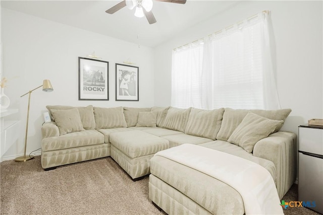 carpeted living room with ceiling fan