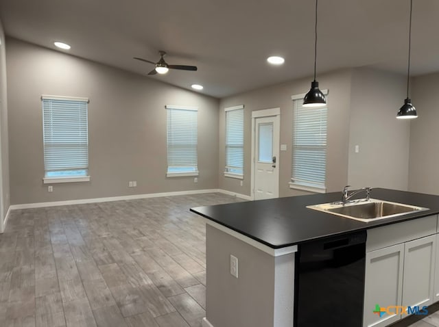 kitchen with ceiling fan, sink, white cabinets, black dishwasher, and hanging light fixtures