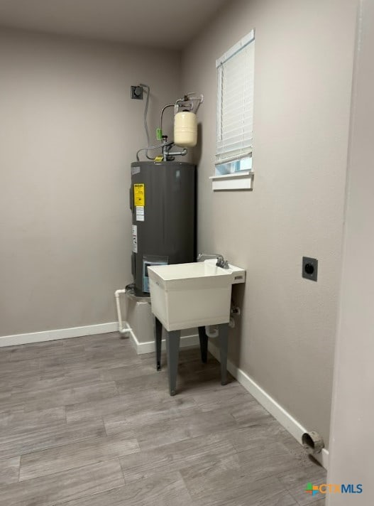 utility room featuring water heater