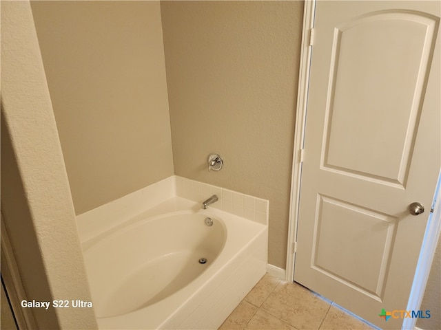 bathroom featuring tile patterned flooring and a washtub