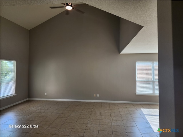 unfurnished room with ceiling fan, light tile patterned flooring, a textured ceiling, and high vaulted ceiling