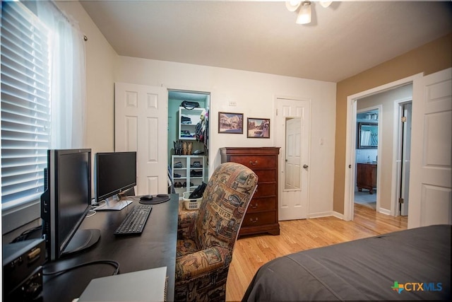 40 Sailfish Lndg, Port Lavaca, TX 77979 - bedroom with light wood-style floors, a desk, and baseboards