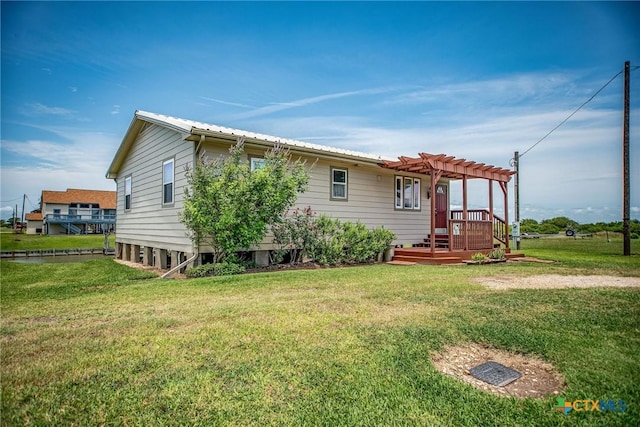 40 Sailfish Lndg, Port Lavaca, TX 77979 - rear view of property featuring a pergola, a lawn, a wooden deck, and metal roof