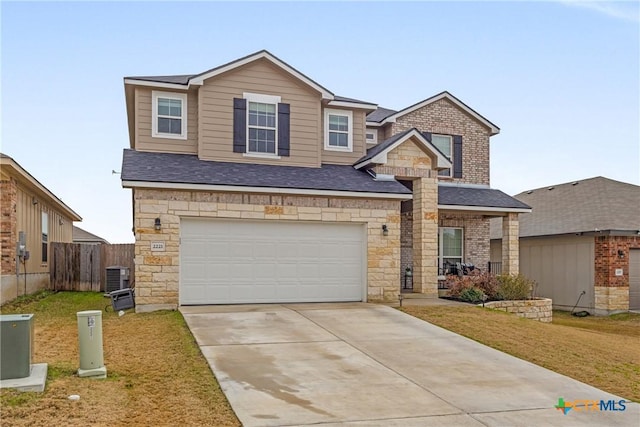 view of front of house featuring a garage, central AC unit, and a front yard