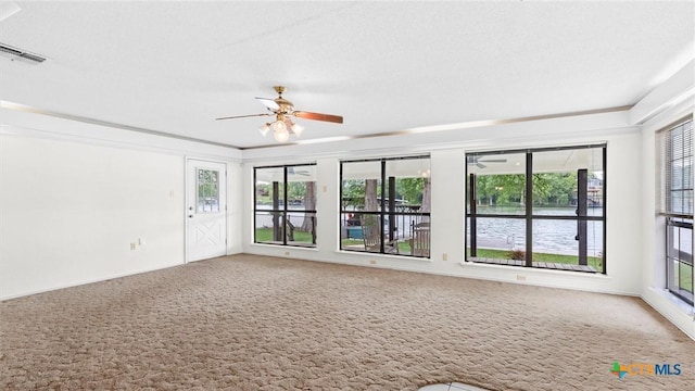 unfurnished room with a ceiling fan, plenty of natural light, and carpet