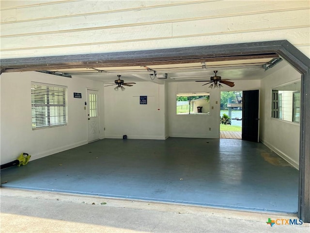 1309 E Zipp Rd, New Braunfels, TX 78130 - garage with ceiling fan and a garage door opener