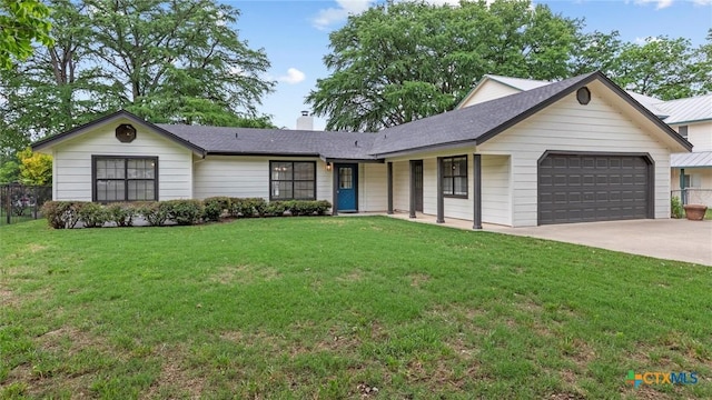 single story home featuring fence, an attached garage, a front yard, a chimney, and driveway