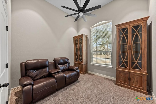 sitting room featuring ceiling fan, baseboards, and carpet flooring