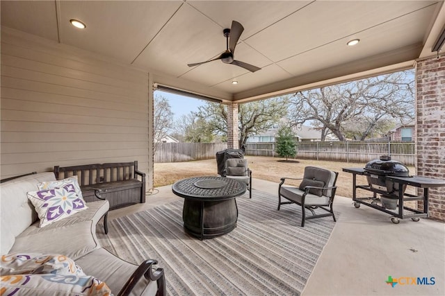 view of patio featuring ceiling fan, outdoor lounge area, and a fenced backyard