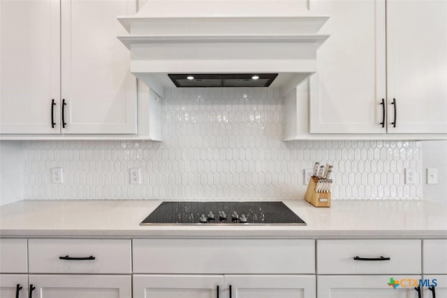 5410 Tabbs Ct, Belton, TX 76513 - kitchen with black electric cooktop, light countertops, white cabinetry, and backsplash