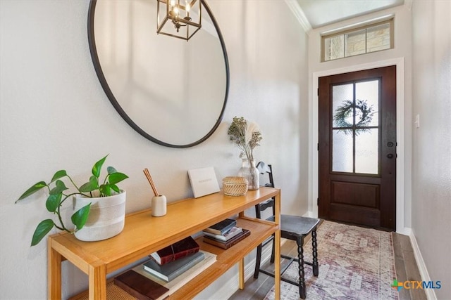 5410 Tabbs Ct, Belton, TX 76513 - entrance foyer featuring baseboards, wood finished floors, a chandelier, and crown molding