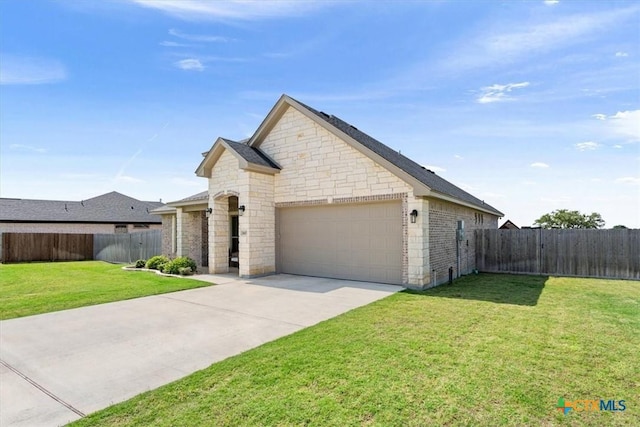 5410 Tabbs Ct, Belton, TX 76513 - french country style house featuring stone siding, an attached garage, and driveway