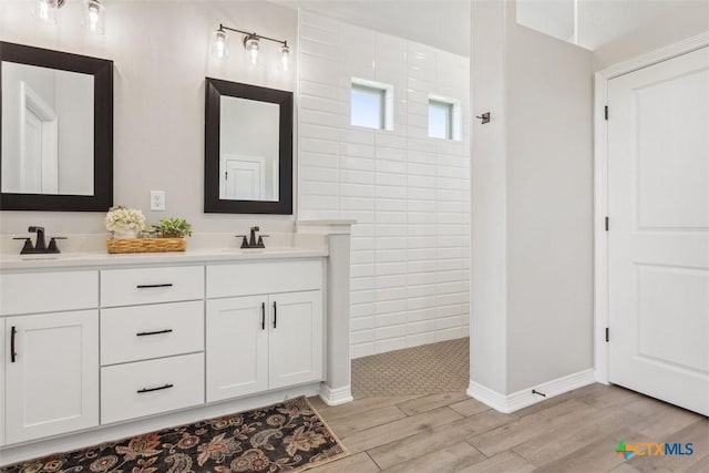 5410 Tabbs Ct, Belton, TX 76513 - full bath with wood finished floors, double vanity, walk in shower, and baseboards