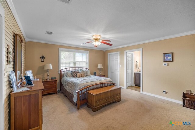 124 County Road 356b, Shiner, TX 77984 - bedroom with ornamental molding, light colored carpet, baseboards, ceiling fan, and connected bathroom