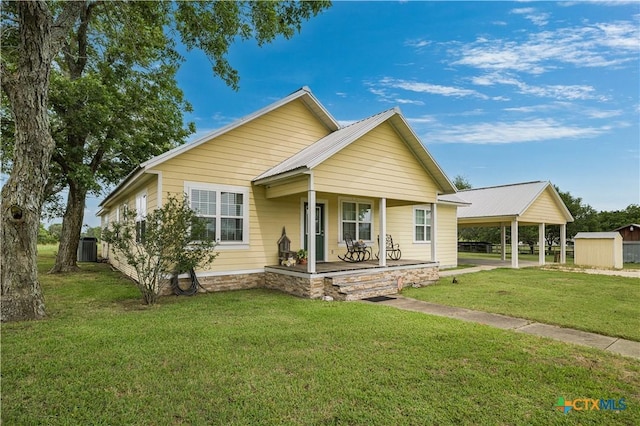 124 County Road 356b, Shiner, TX 77984 - bungalow-style home with covered porch, a front lawn, central air condition unit, and an outdoor structure
