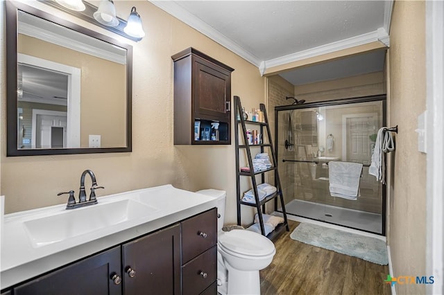 124 County Road 356b, Shiner, TX 77984 - bathroom featuring ornamental molding, a shower stall, wood finished floors, vanity, and toilet