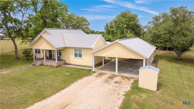 124 County Road 356b, Shiner, TX 77984 - view of front of property featuring driveway, a porch, a front yard, and a carport