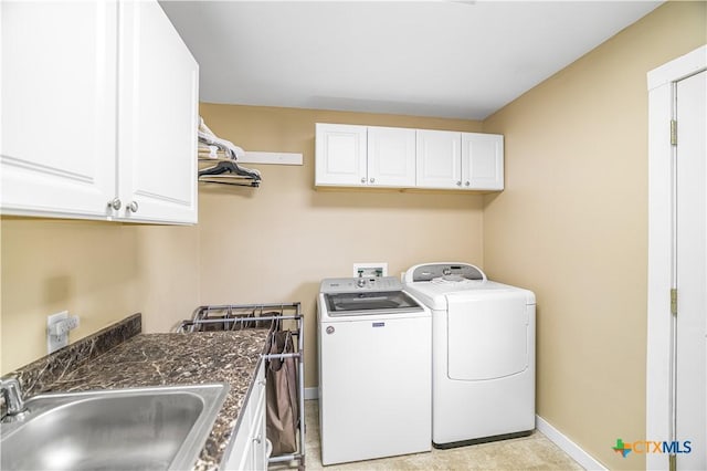 124 County Road 356b, Shiner, TX 77984 - washroom featuring cabinet space, separate washer and dryer, and baseboards
