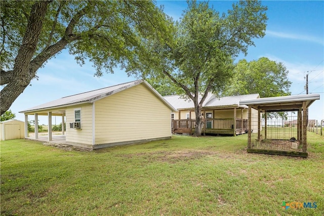 124 County Road 356b, Shiner, TX 77984 - rear view of house featuring a yard, metal roof, a deck, and cooling unit