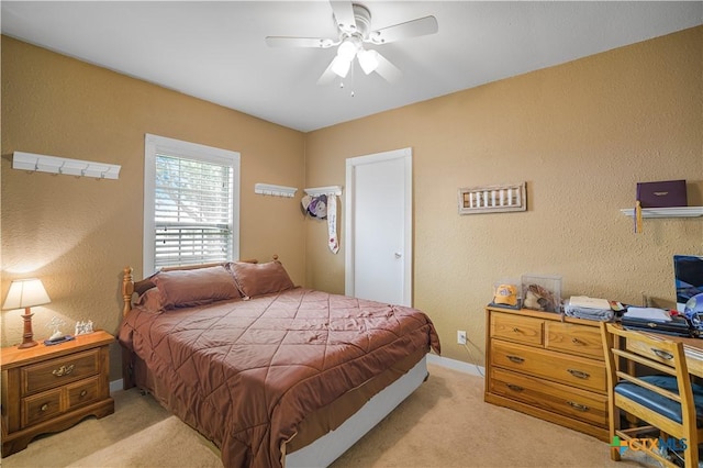 124 County Road 356b, Shiner, TX 77984 - bedroom with light carpet, a textured wall, a ceiling fan, and baseboards