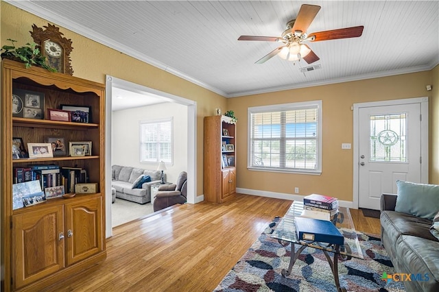 124 County Road 356b, Shiner, TX 77984 - living area featuring ceiling fan, healthy amount of natural light, crown molding, light wood finished floors, and baseboards