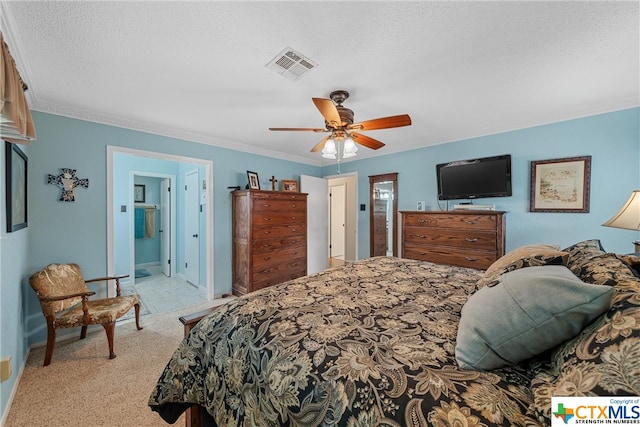 bedroom featuring a textured ceiling, light carpet, connected bathroom, ornamental molding, and ceiling fan