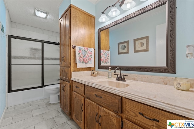 full bath with enclosed tub / shower combo, a textured ceiling, toilet, vanity, and tile patterned floors