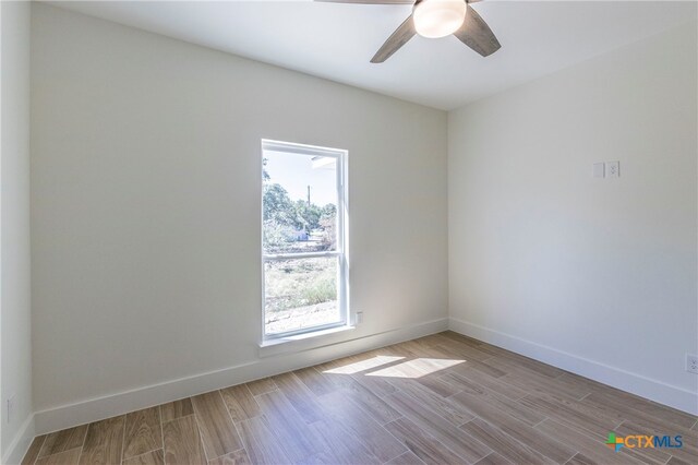 spare room with ceiling fan and light hardwood / wood-style flooring