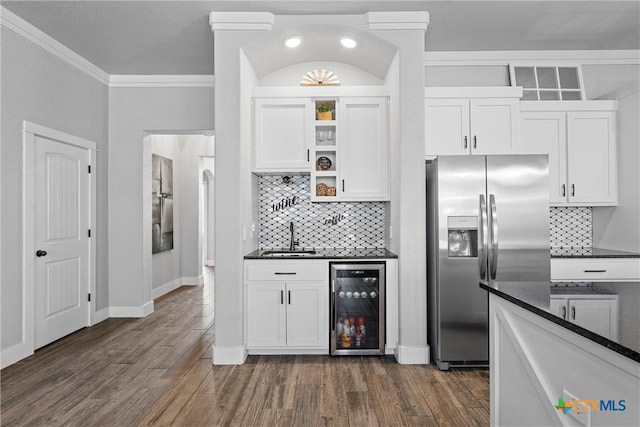 kitchen featuring wine cooler, stainless steel refrigerator with ice dispenser, open shelves, white cabinetry, and a sink