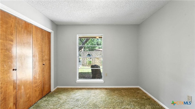 162 Lone Oak St, Seguin, TX 78155 - unfurnished bedroom with carpet flooring, a closet, and a textured ceiling