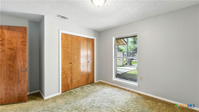 162 Lone Oak St, Seguin, TX 78155 - unfurnished bedroom with carpet floors, a closet, and a textured ceiling
