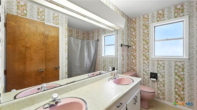 162 Lone Oak St, Seguin, TX 78155 - full bathroom with wallpapered walls, double vanity, a textured ceiling, and curtained shower