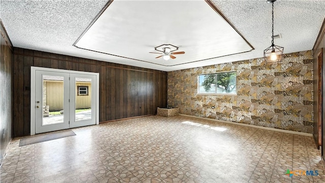 162 Lone Oak St, Seguin, TX 78155 - spare room with wooden walls, a ceiling fan, and a textured ceiling