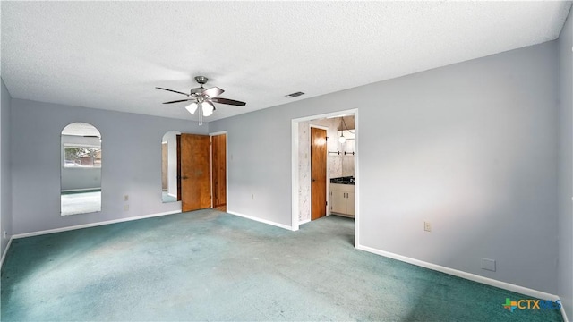 162 Lone Oak St, Seguin, TX 78155 - unfurnished bedroom with carpet, a textured ceiling, a ceiling fan, arched walkways, and ensuite bath