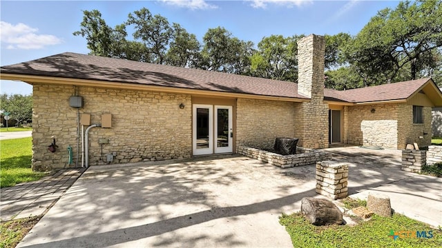 162 Lone Oak St, Seguin, TX 78155 - back of house featuring a chimney, stone siding, and a patio