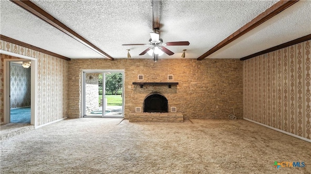 162 Lone Oak St, Seguin, TX 78155 - unfurnished living room with ceiling fan, beam ceiling, a fireplace with raised hearth, a textured ceiling, and carpet flooring