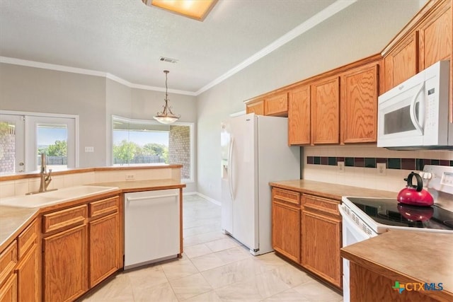 6809 Oak Vw, Belton, TX 76513 - kitchen with white appliances, ornamental molding, brown cabinets, and hanging light fixtures