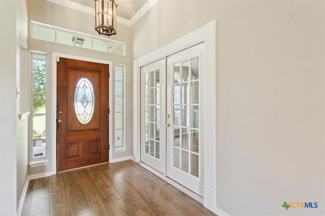 6809 Oak Vw, Belton, TX 76513 - foyer with french doors, ornamental molding, a chandelier, and wood finished floors
