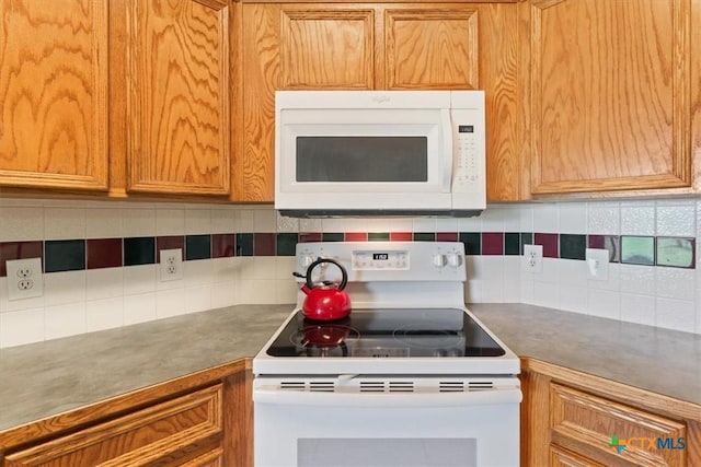 6809 Oak Vw, Belton, TX 76513 - kitchen with white appliances, tasteful backsplash, and brown cabinetry
