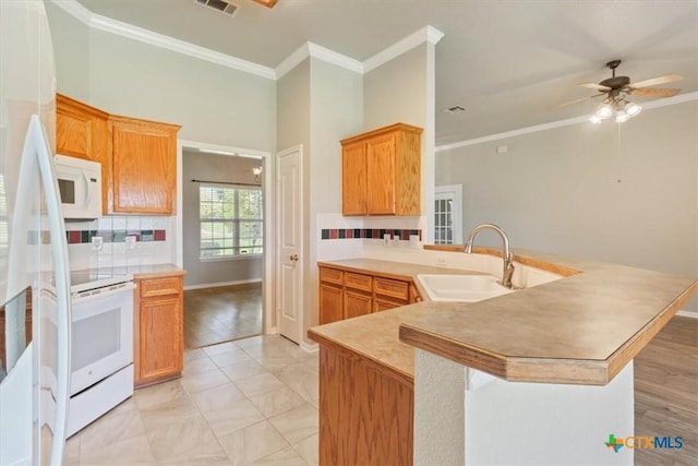 6809 Oak Vw, Belton, TX 76513 - kitchen with white appliances, ornamental molding, a peninsula, tasteful backsplash, and ceiling fan