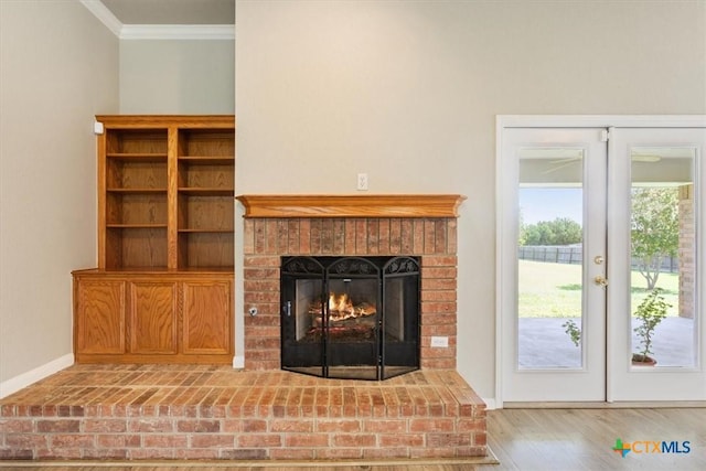 6809 Oak Vw, Belton, TX 76513 - unfurnished living room featuring ornamental molding, wood finished floors, french doors, and a brick fireplace