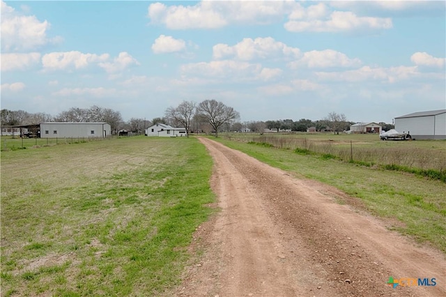 view of road featuring driveway and a rural view