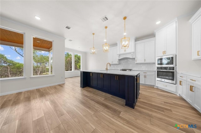 5273 Comanche Dr, Temple, TX 76502 - kitchen featuring appliances with stainless steel finishes, light countertops, white cabinets, decorative backsplash, and recessed lighting