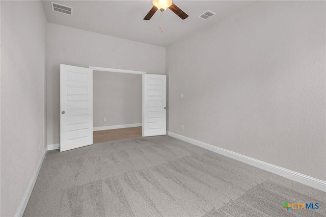 empty room featuring carpet and ceiling fan