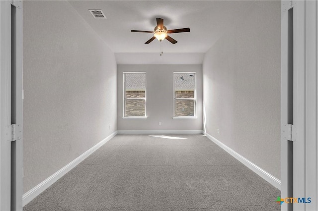 carpeted spare room with ceiling fan